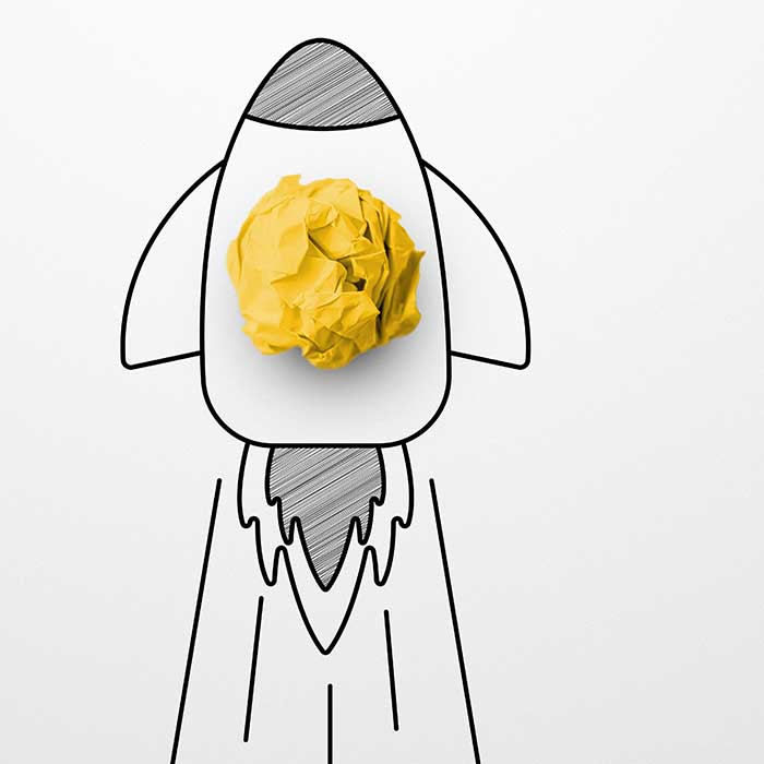 Rocket sketch drawing cartoon with crumpled paper ball on white background. Successful business startup. Creative thinking ideas and innovation concept